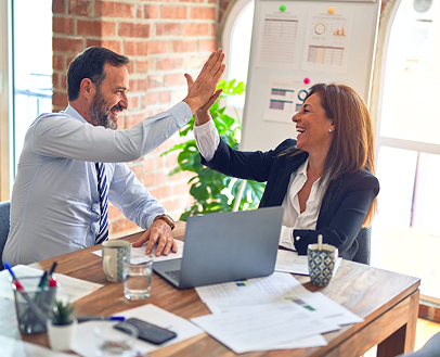 A woman and a man high-five each other