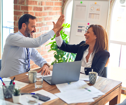 A woman and a man high-five each other